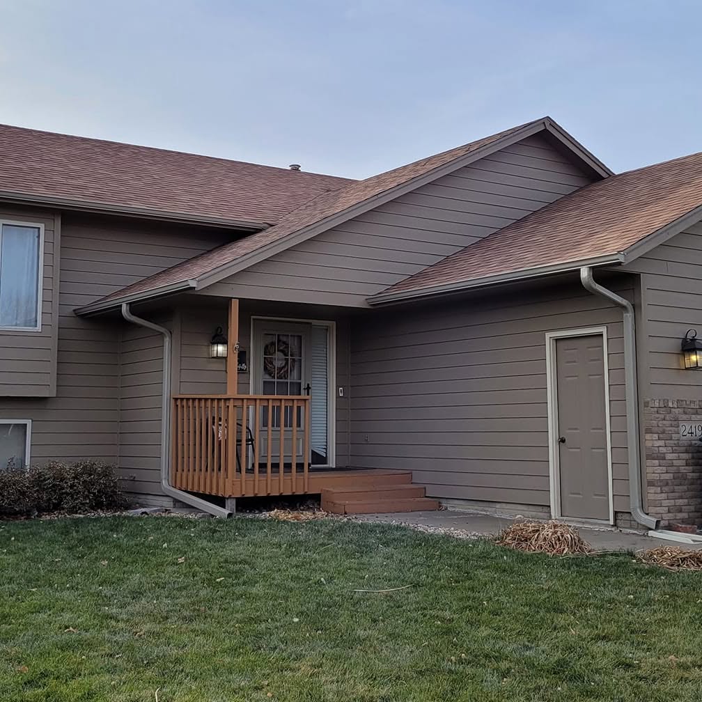 Home with a new roof and seamless gutters by Clark Roofing